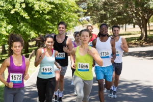 Happy people running race in park on a sunny day