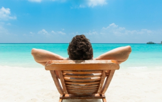 Man lying on lounger at beach