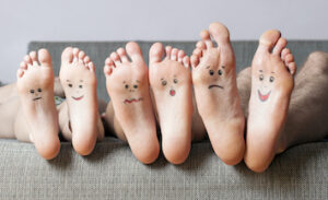 Picture of feet with smiling faces on the bottom