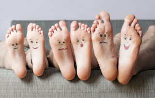 Picture of feet with smiling faces on the bottom