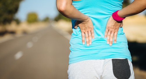 Picture of woman holding sore lower back