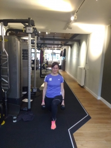 Client lunging holding dumbbells